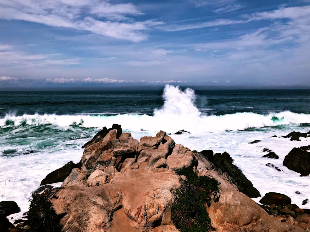 ocean waves on rock during daytime