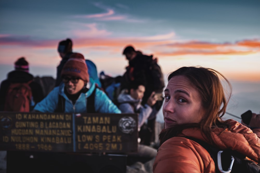 shallow focus photo of woman in brown hoodie