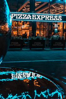 Exterior shot of Arte Bianca pizzeria in Tisselt during golden hour.