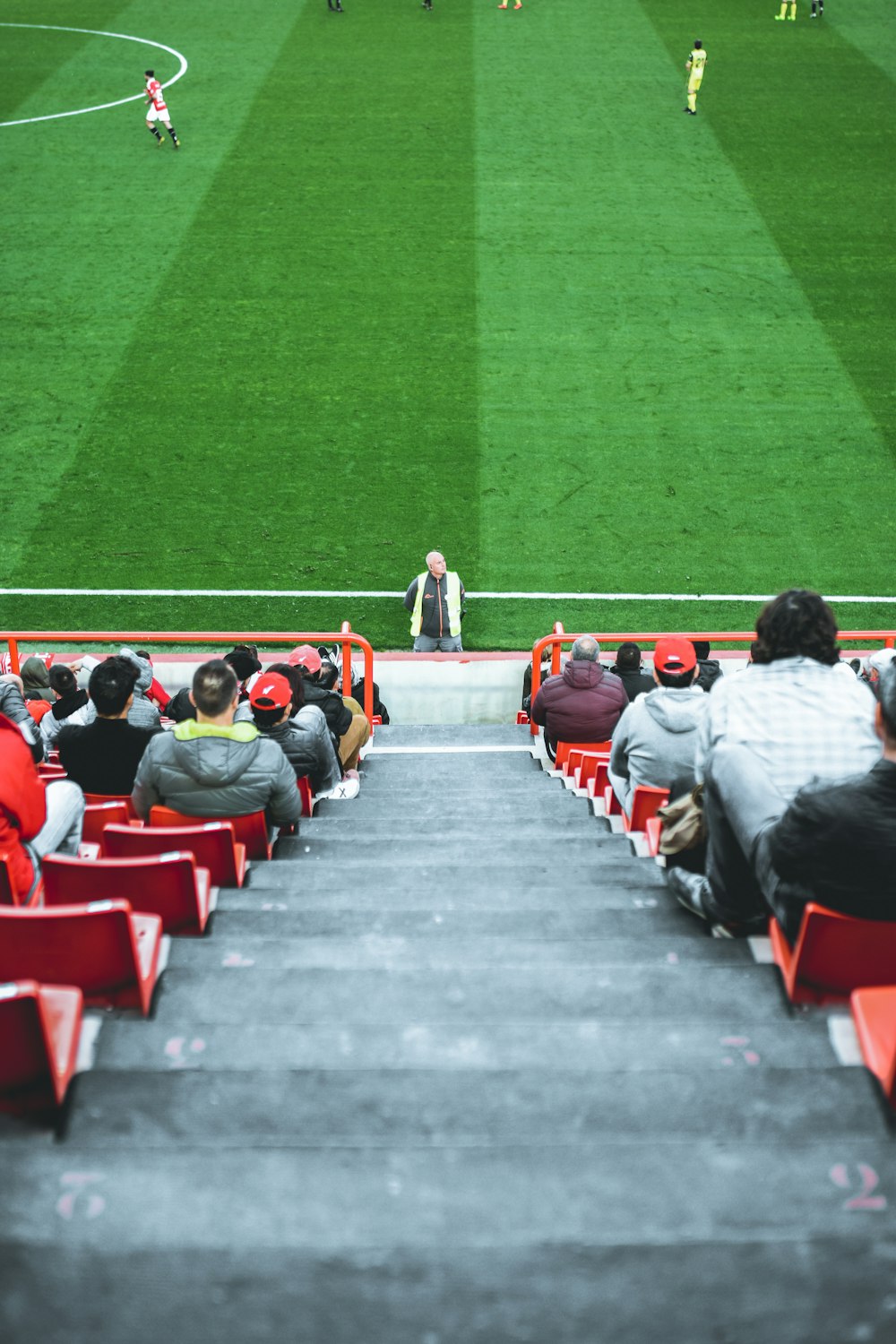 people sitting on arena bench