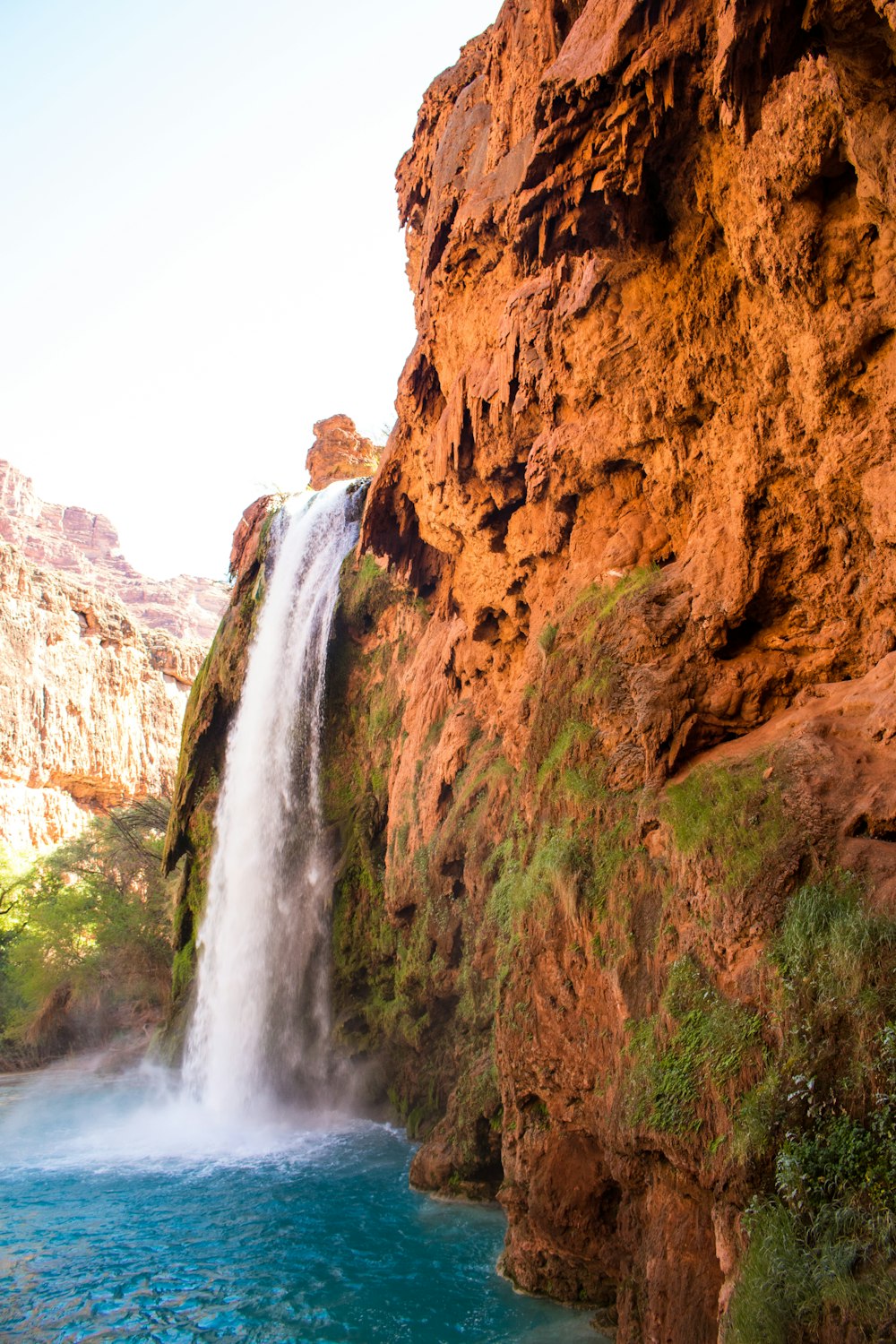 waterfalls under white sky