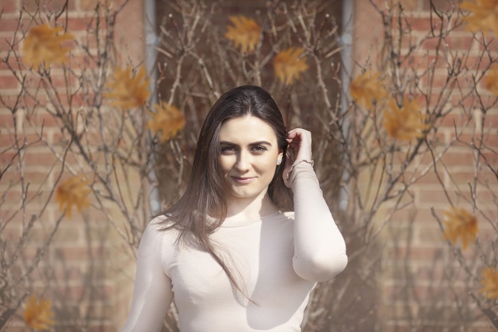 woman on front of brown tree