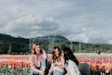 3 women sitting on bench near the flowers