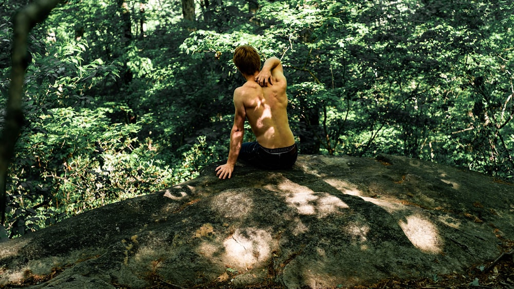 man sitting on rock