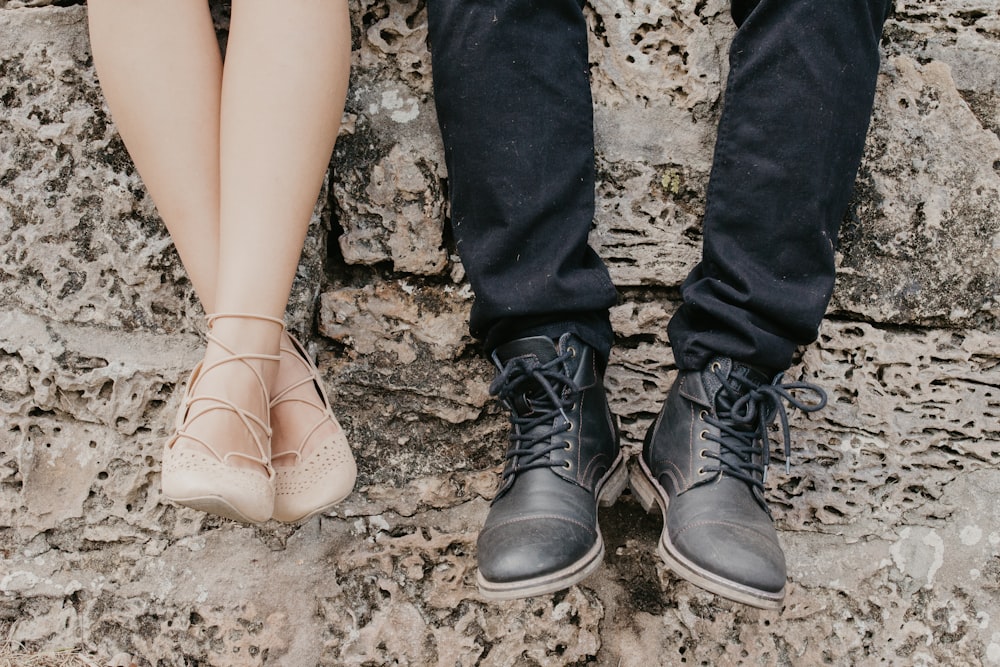 man wearing black shoes beside woman wearing flats