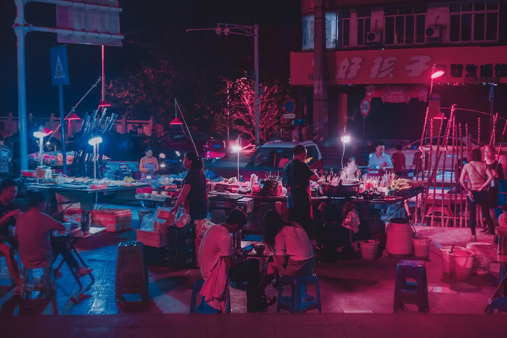 a group of people sitting around a table at night