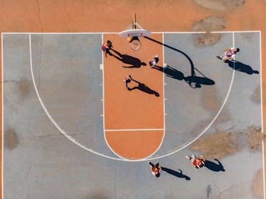 A dynamic basketball court filled with players engaged in a game.