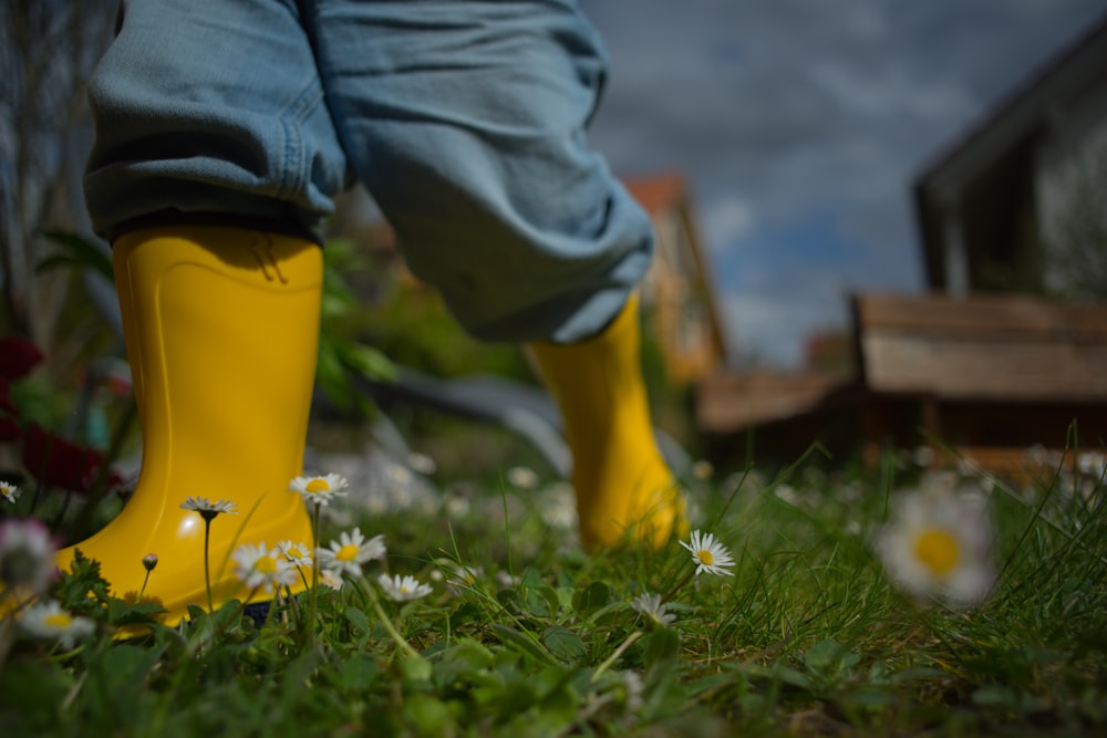 person wearing yellow rain boots during daytime