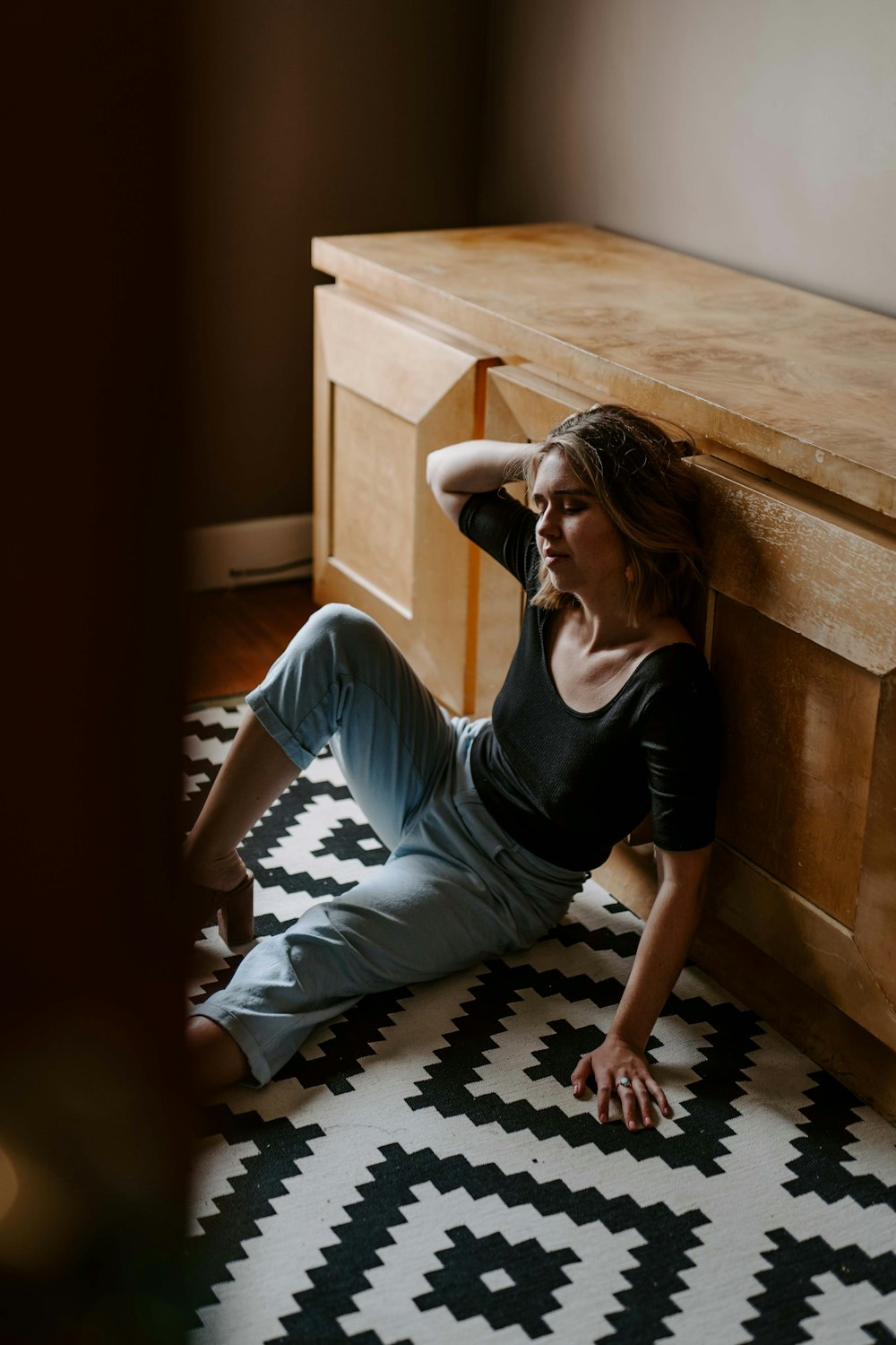 woman sitting near sideboard