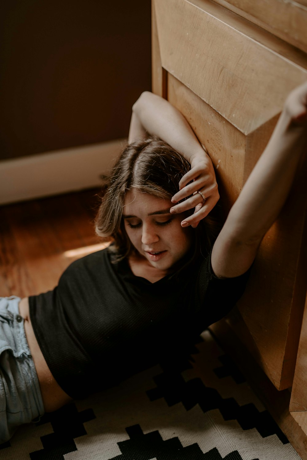 woman leaning on cabinet