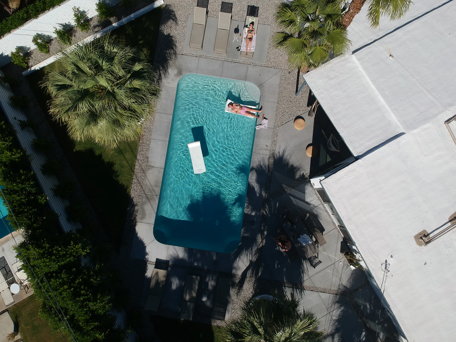 Aerial view of a pool surrounded by palms