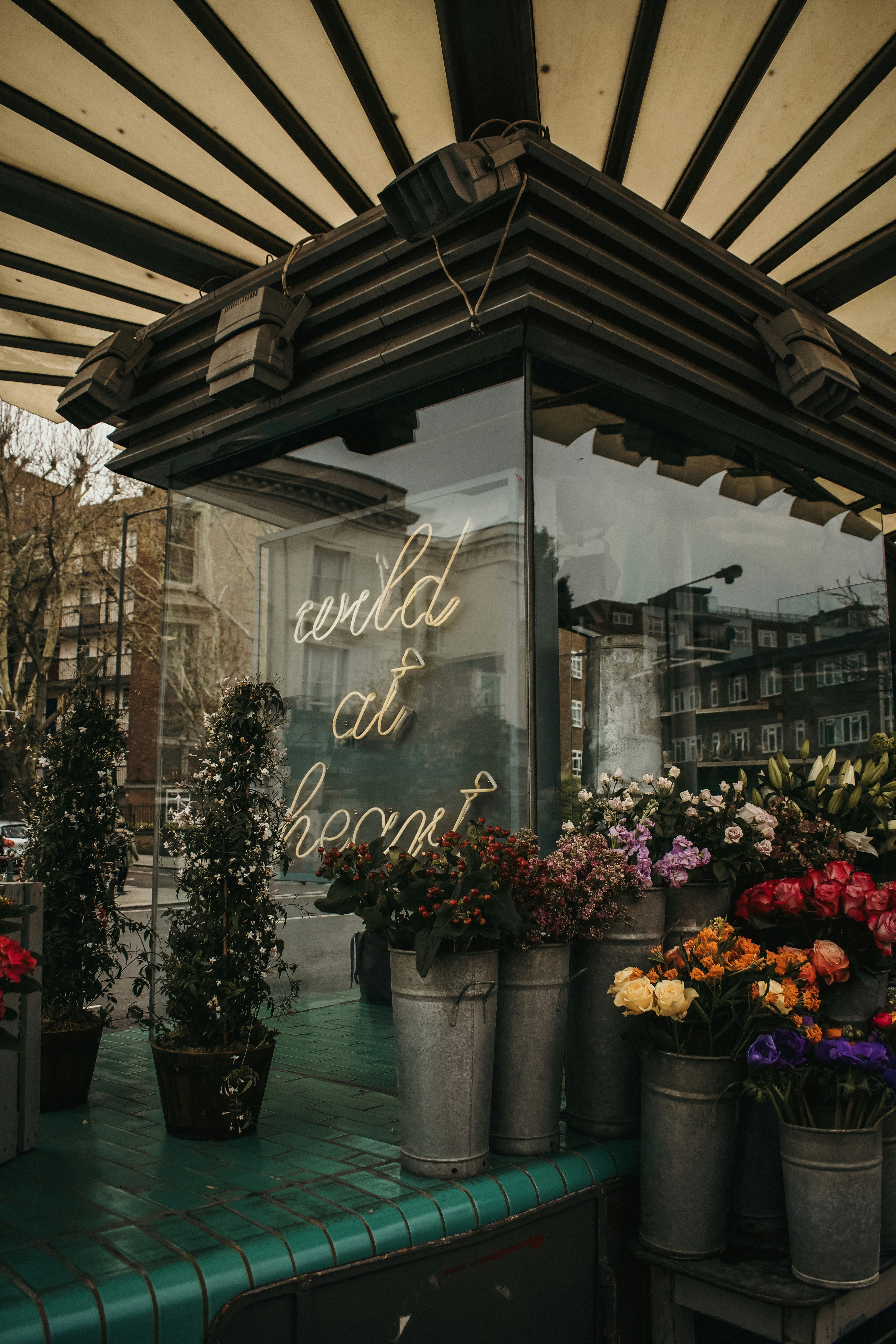assorted flowers inside grey metal can