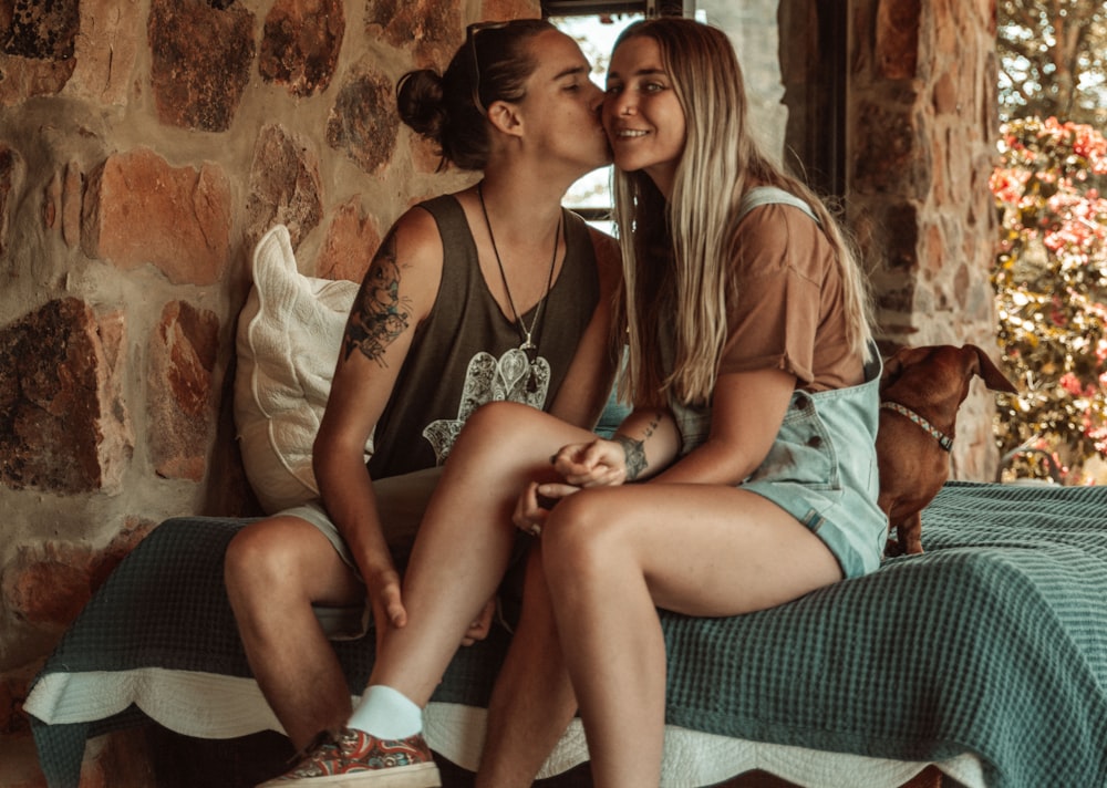 picture of a woman kissing another woman on the cheek