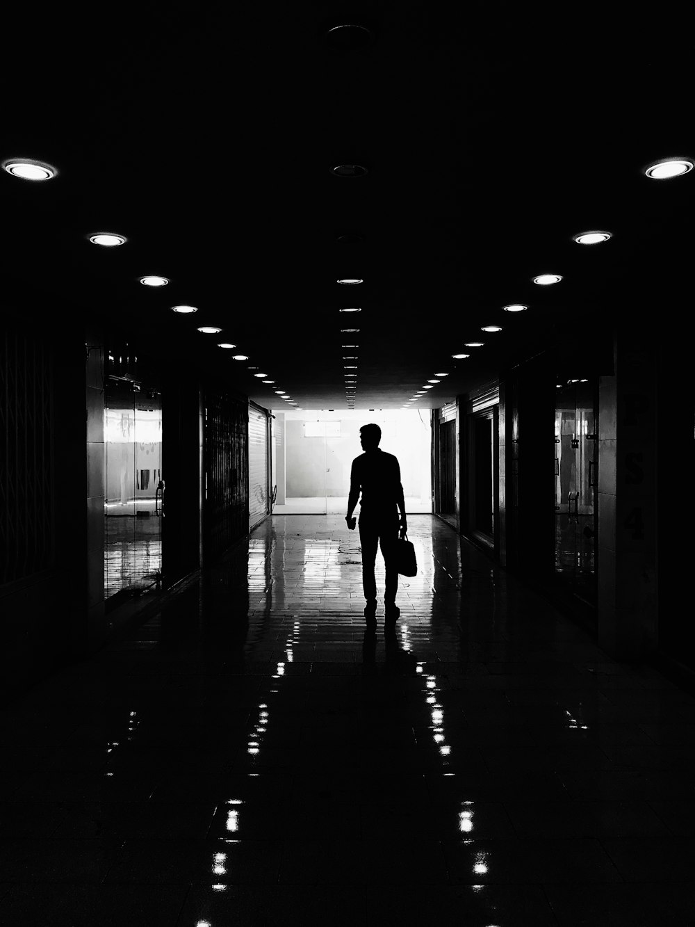 silhouette of person walking on hallway