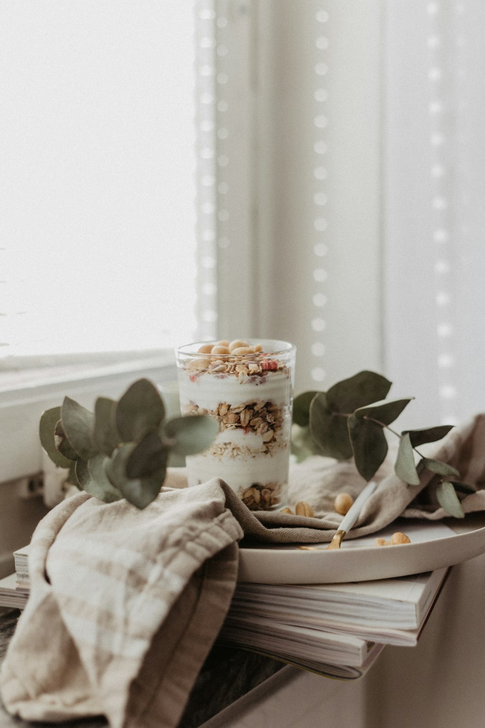 a glass of yogurt sitting on top of a table