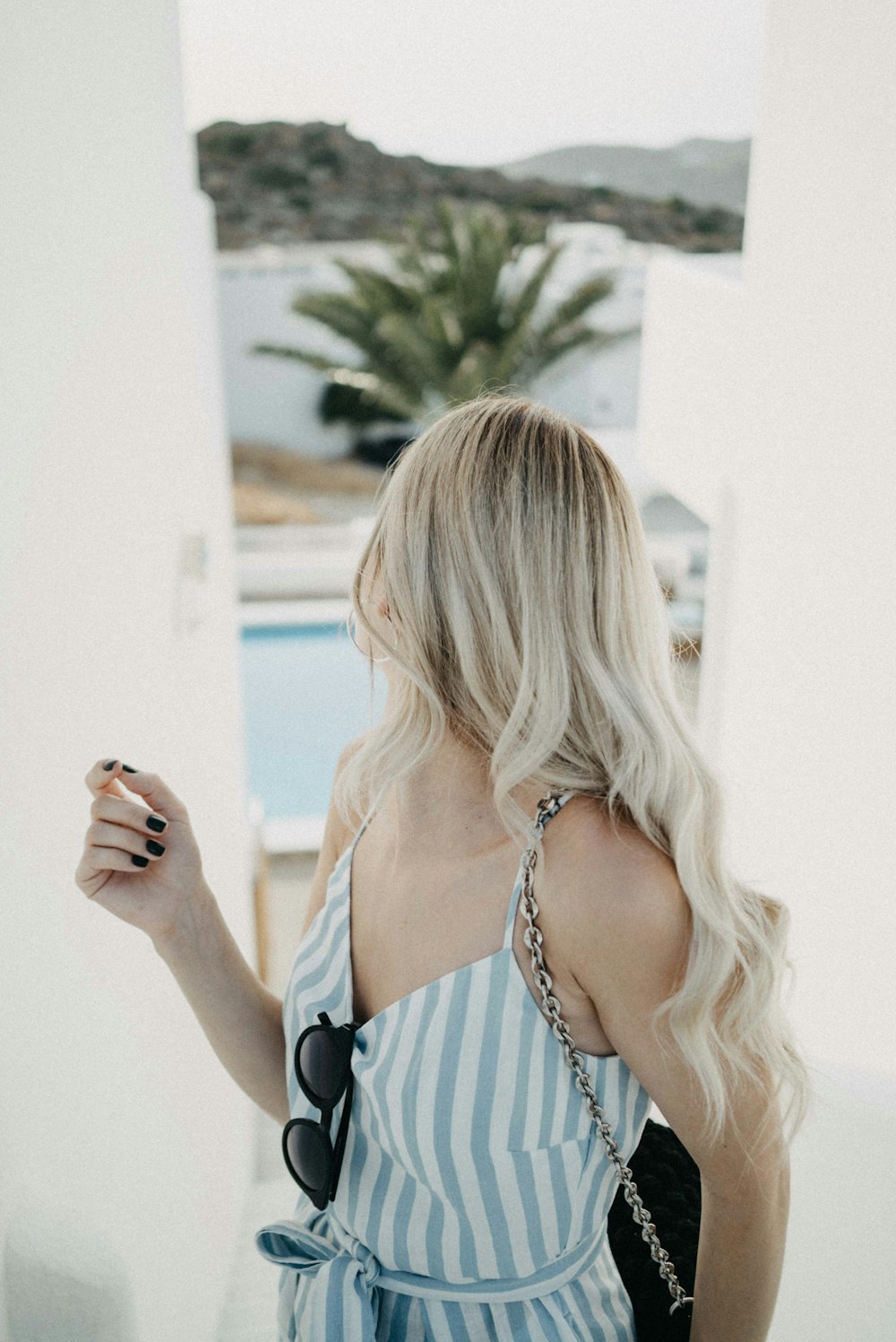 woman wearing white and grey stripe spaghetti strap tops