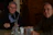 Two business leaders discussing strategy over coffee in a bright, cozy cafe.