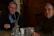 Two business leaders discussing strategy over coffee in a bright, cozy cafe.