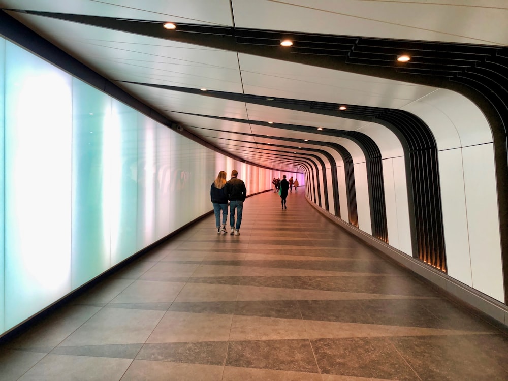 man and woman walking inside structure