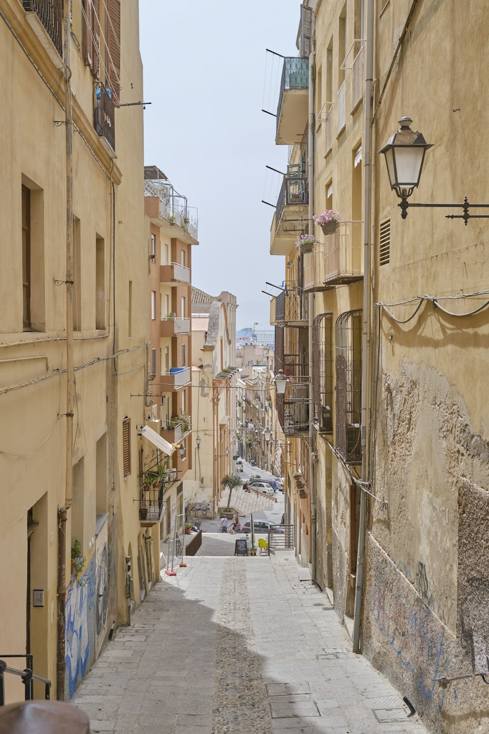 empty street in between concrete buildings during daytime