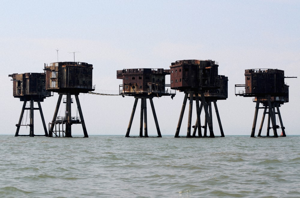 six brown concrete towers on body of water during daytime