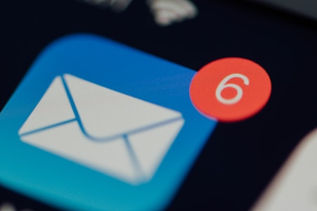 An email icon with a blue background and a white envelope is prominently displayed. A red notification bubble with the number 6 is overlaid on the icon.