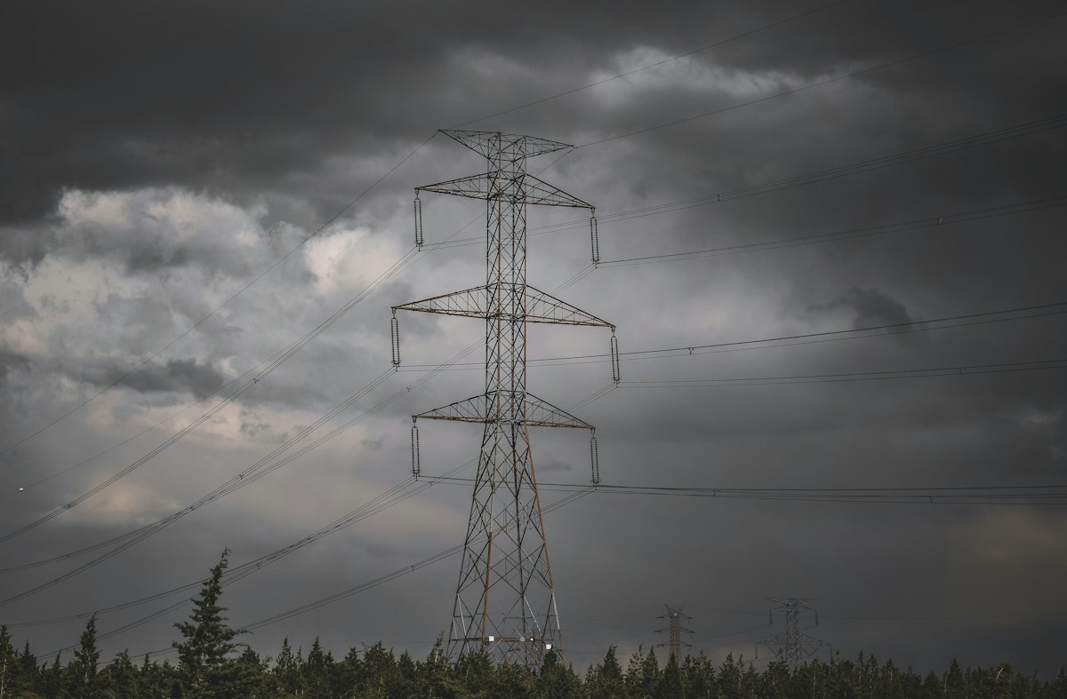 Overhead power lines and utility pole carrying three phase power from a transformer with a defined vector group