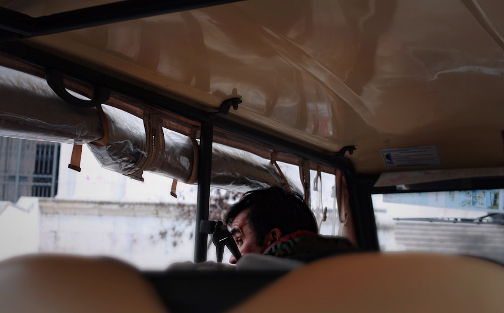 man in vehicle looking outside