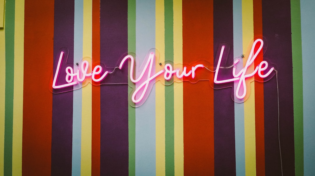 pink love you life neon signage