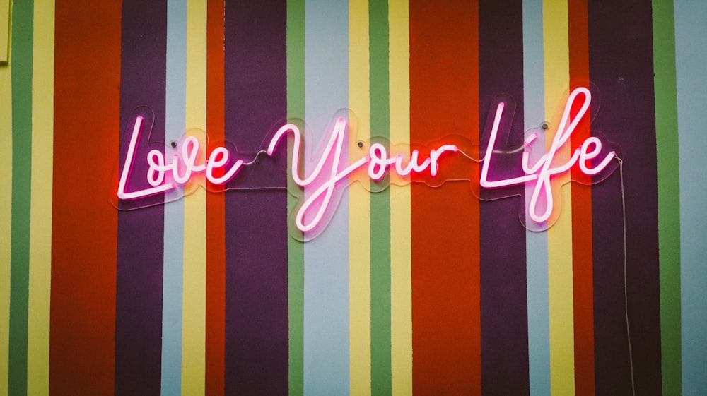 pink love you life neon signage
