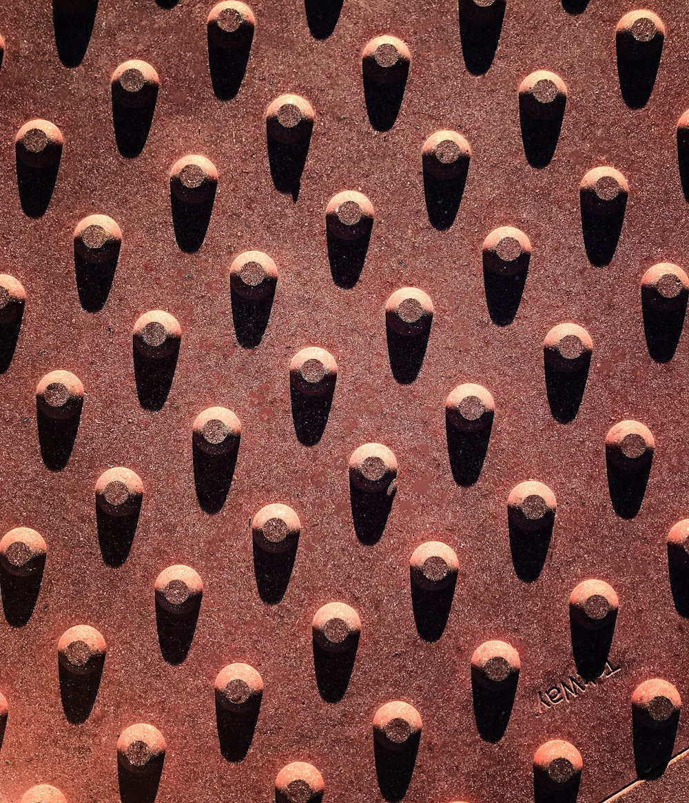 a bunch of black vases are lined up on a wall