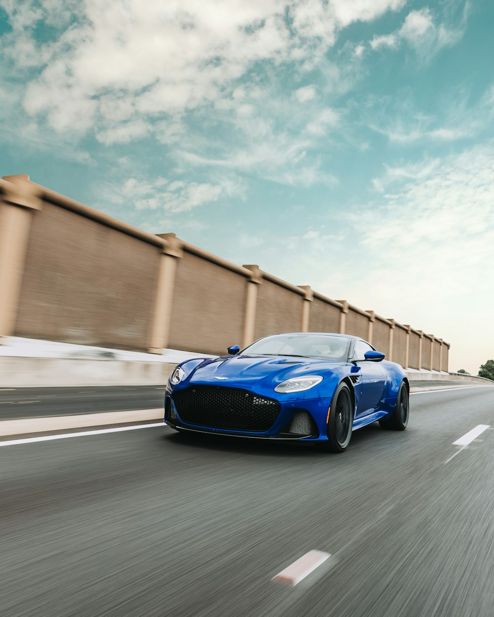 blue sports coupe on road