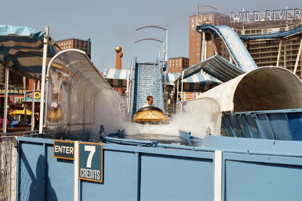 person sitting on water boat theme park ride during daytime