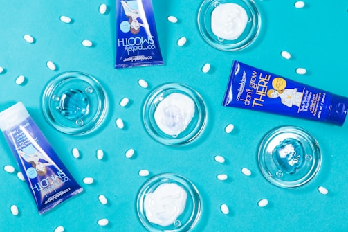 Flat lay of skincare products with blue packaging and natural elements