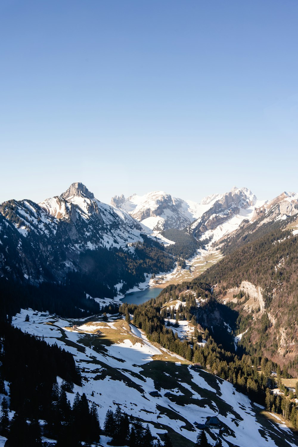 a view of a mountain range with a lake in the middle