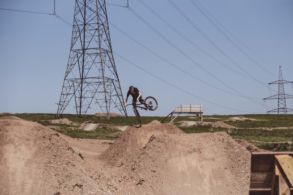 person riding bicycle near transmission power