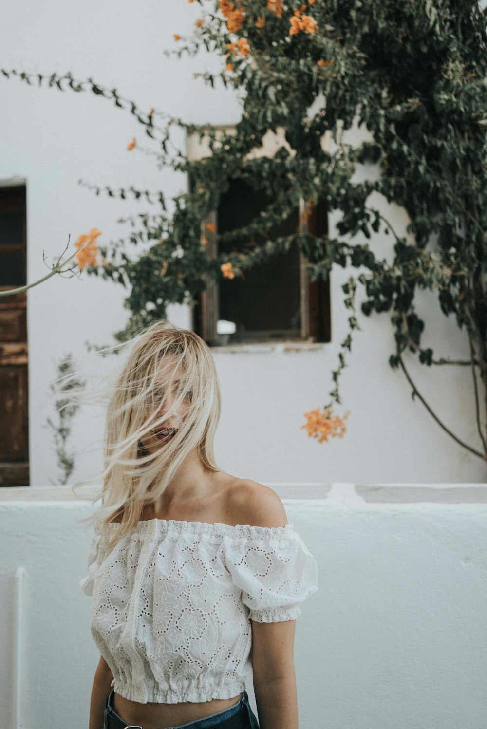 woman wearing white off-shoulder top