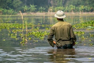 man soaked in body of water colonial google meet background