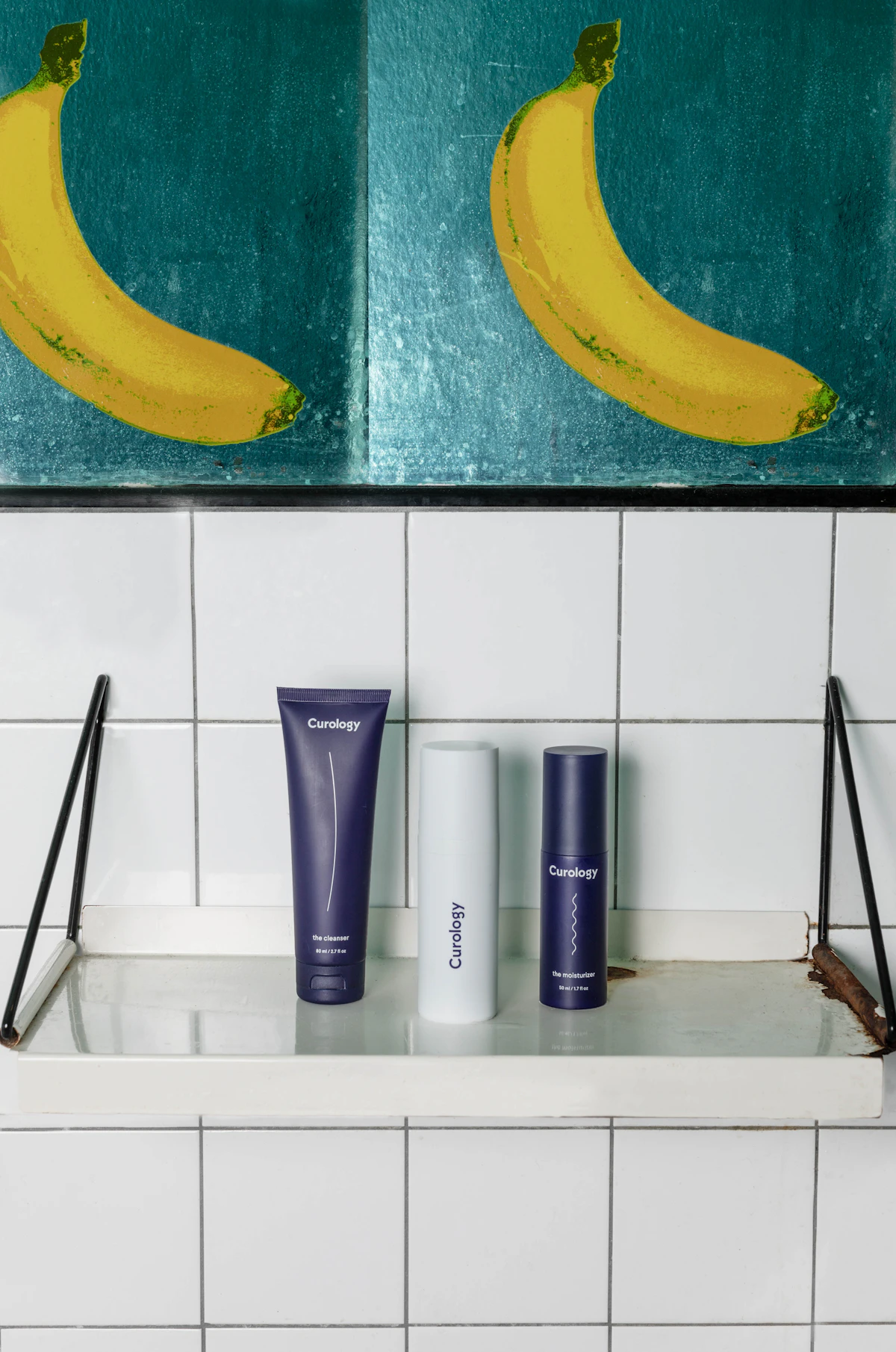 Matching dispensers lined up on a small bathroom shelf