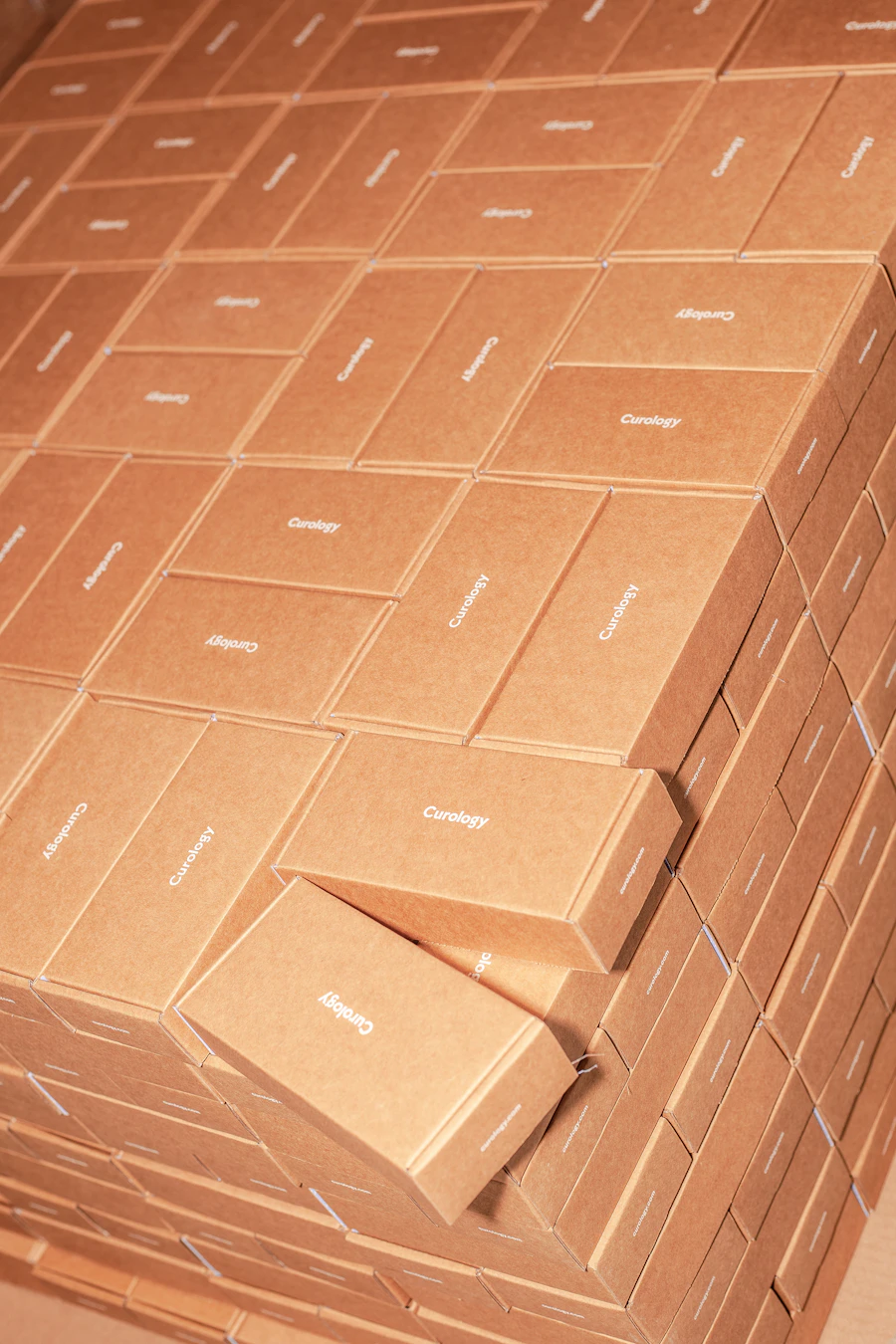 A brown cardboard shipping box with a printed shipping label attached