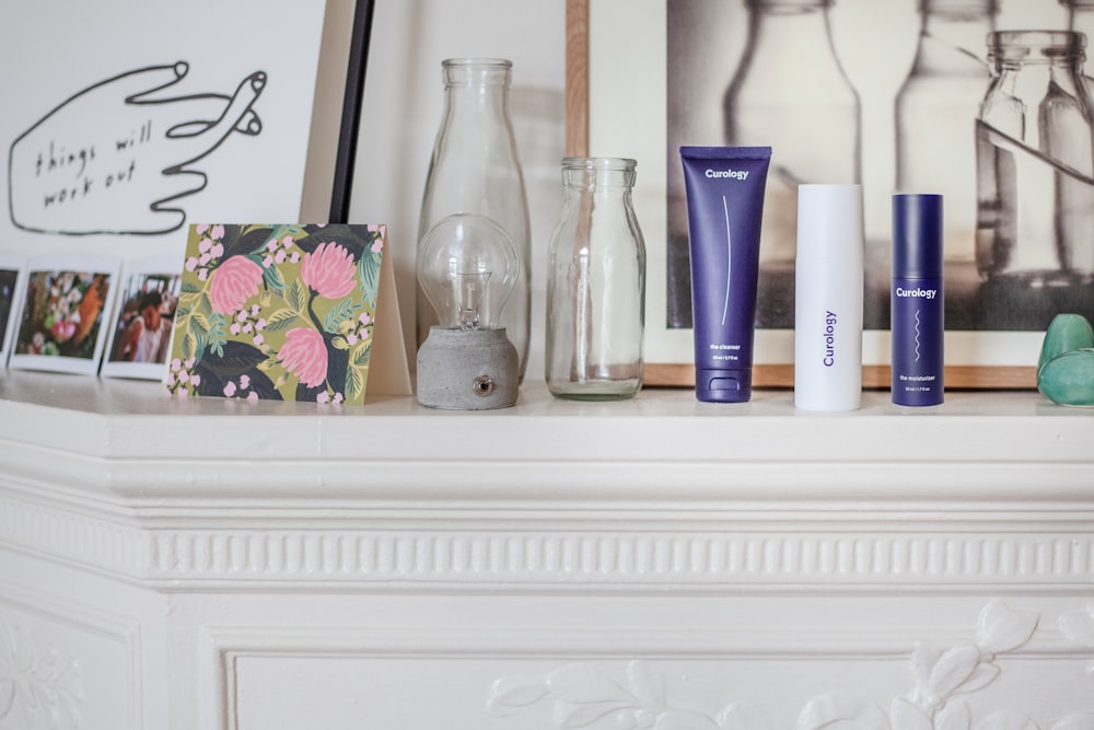 photo frames beside clear glass jar