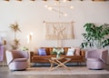 brown leather sofa and two pink sofa chair