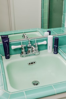 A sparkling bathroom sink area featuring eco-friendly cleaning products and soft towels.