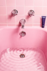 white bathtub filled with water
