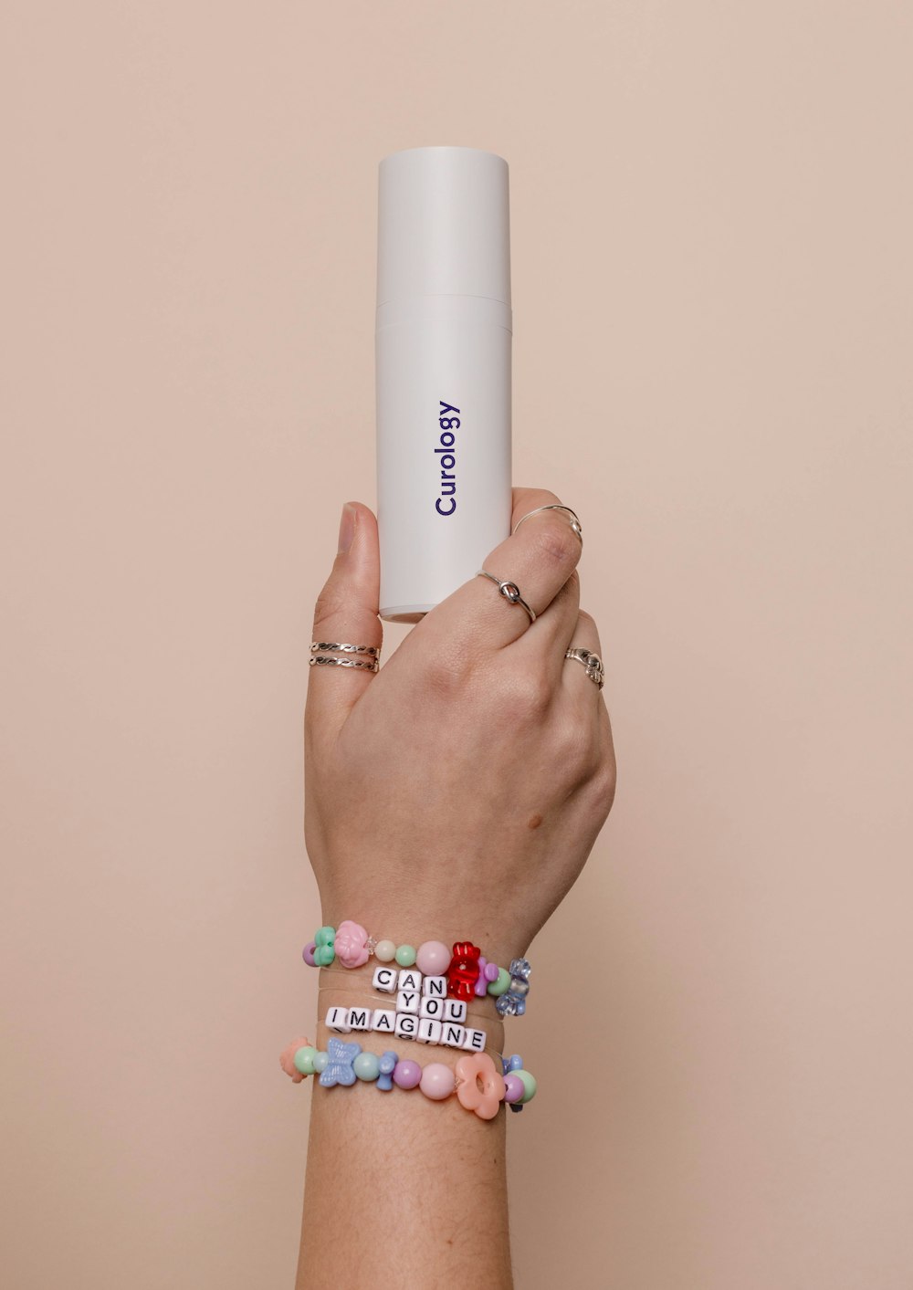 a person holding a white tube in their hand