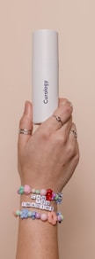 a person holding a white tube in their hand