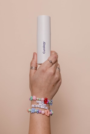 a person holding a white tube in their hand