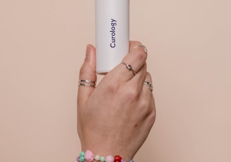 a person holding a white tube in their hand