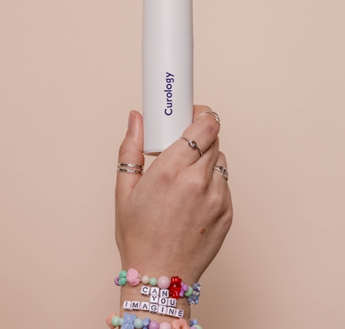 a person holding a white tube in their hand