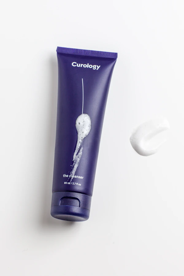 Woman applying skincare, representing topical versus internal skin health approaches